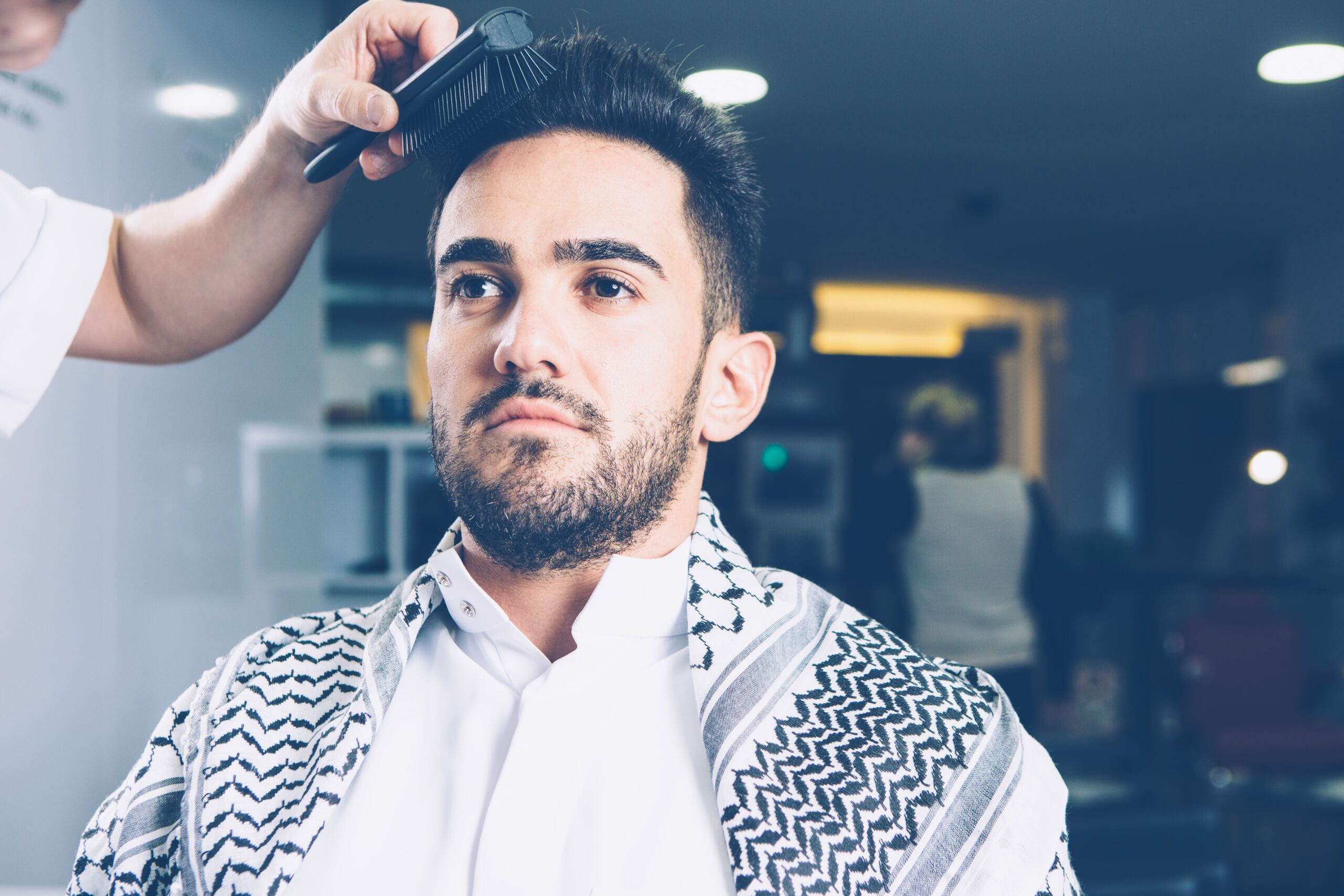 Man getting a haircut at barbershop.